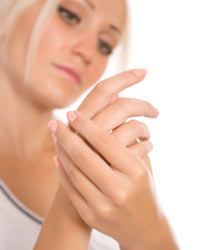 woman examining her hands