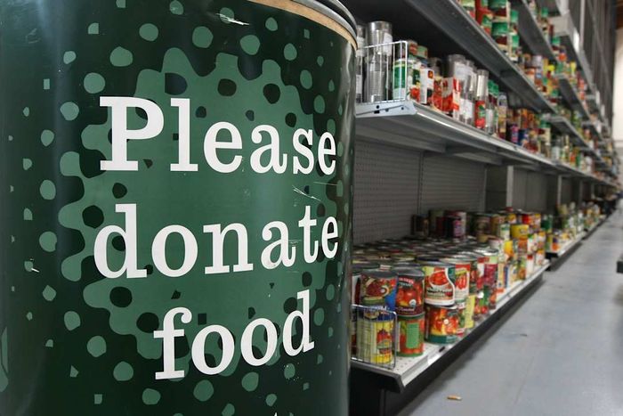 A sign inside a food bank urging people to contribute food items.