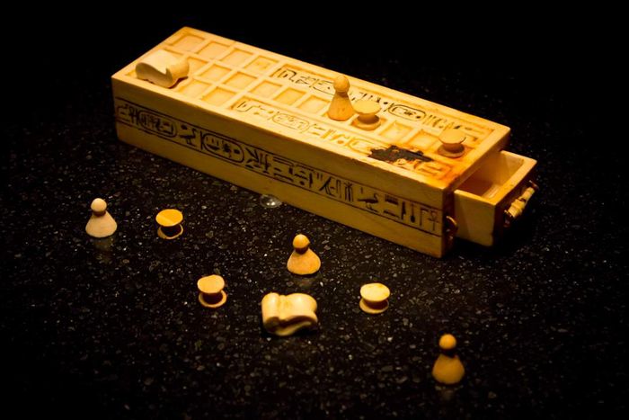 A Senet game board placed on a table.