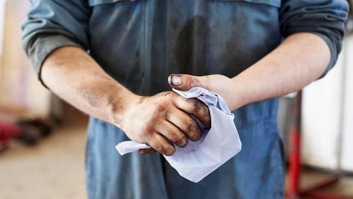 A man with dirty hands is shown