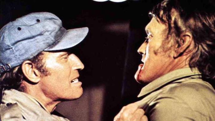 Charlton Heston (left) faces off against Chuck Connors (right) in the iconic film 'Soylent Green.'