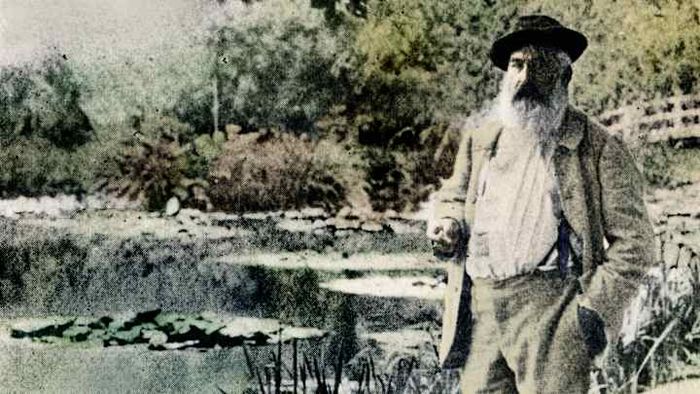 Claude Monet standing before his iconic water lilies at his Giverny gardens in 1905.