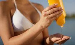 A woman applying sunscreen