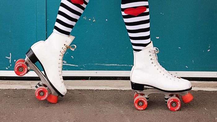 A person’s legs wearing roller skates