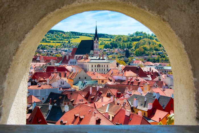 A view of Český Krumlov framed by an ancient archway