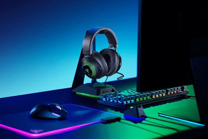 The Razer Kraken Ultimate RGB USB Gaming Headset set up on a desktop.