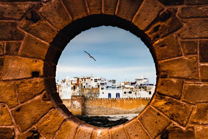 A sunset view of Essaouira seen through a porthole