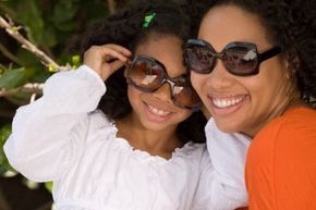 A mother and daughter sporting sunglasses.