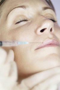 A woman undergoing a lip injection procedure to enhance her appearance.