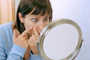 Woman examining her reflection in a mirror