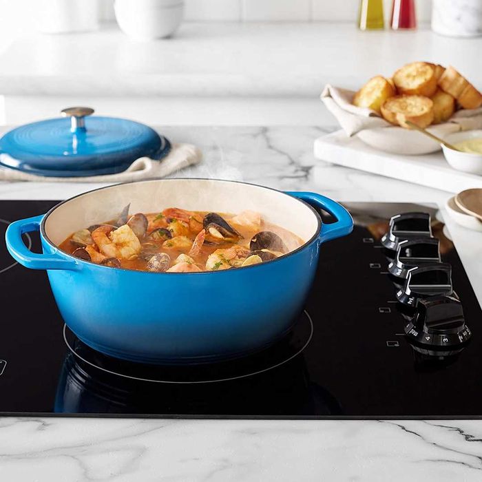 Amazon Basics Enameled Cast Iron Covered Dutch Oven displayed on a stove.