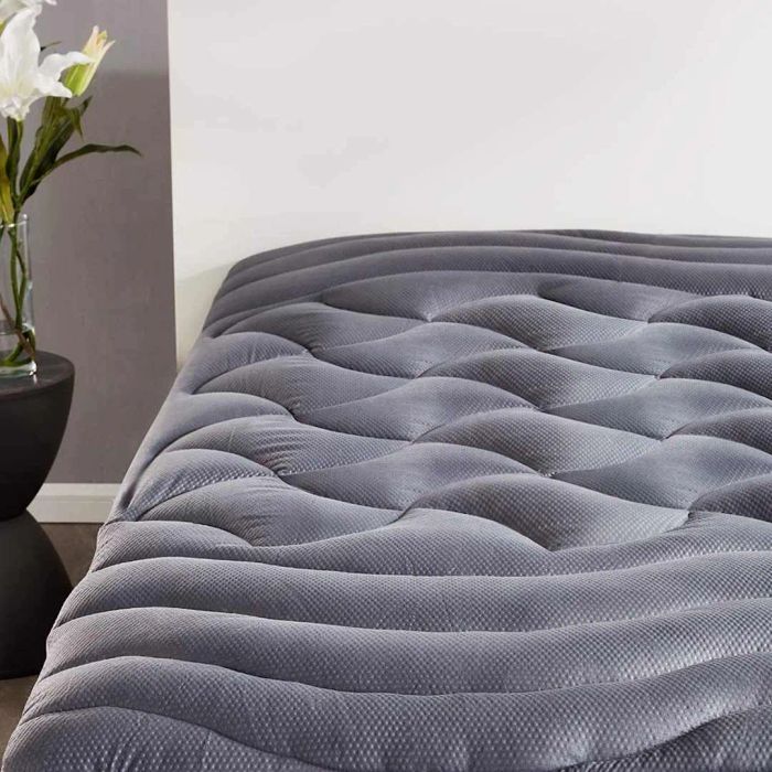 A SLEEP ZONE Cooling Queen Mattress Pad placed on a mattress in a bedroom setting