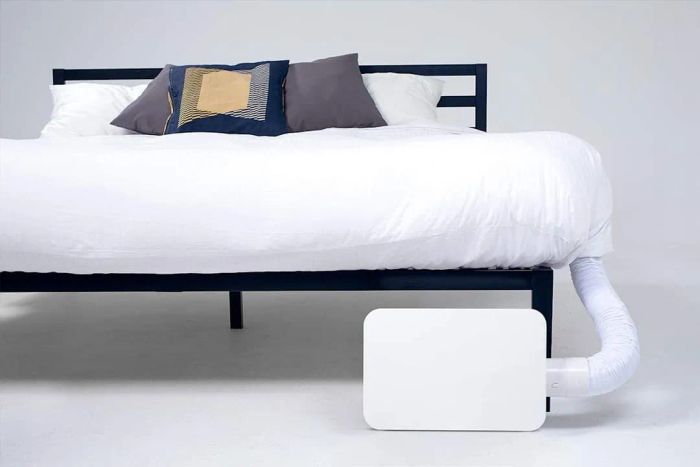 A BedJet 3 Climate Comfort Cooling Fan installed on a bed