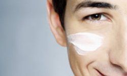 a man applying lotion to his face