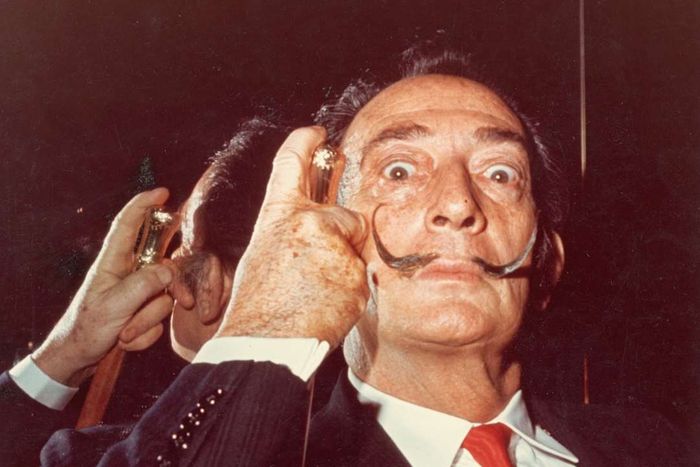 A photograph of Salvador Dalí gripping a cane.