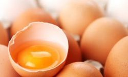 brown eggs with one cracked open to reveal yolk and egg white