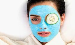 woman applying a clay face mask