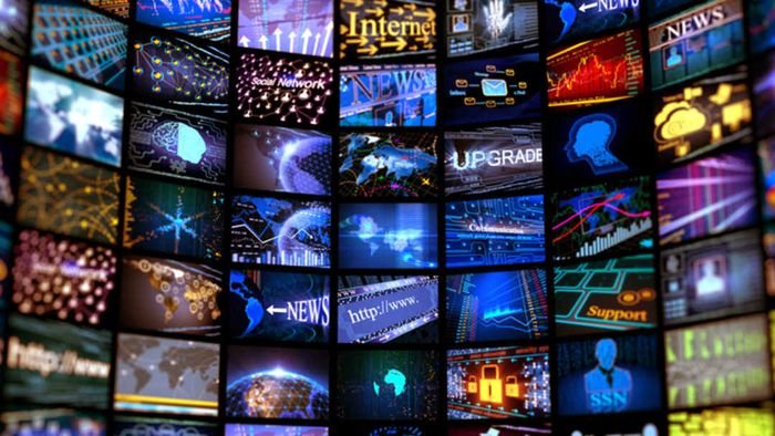 A wall filled with TV screens