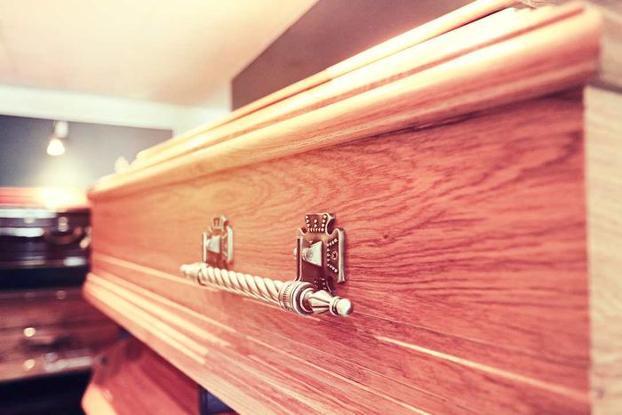 Close-up shot of the side of a wooden coffin