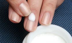 Woman applying hand cream