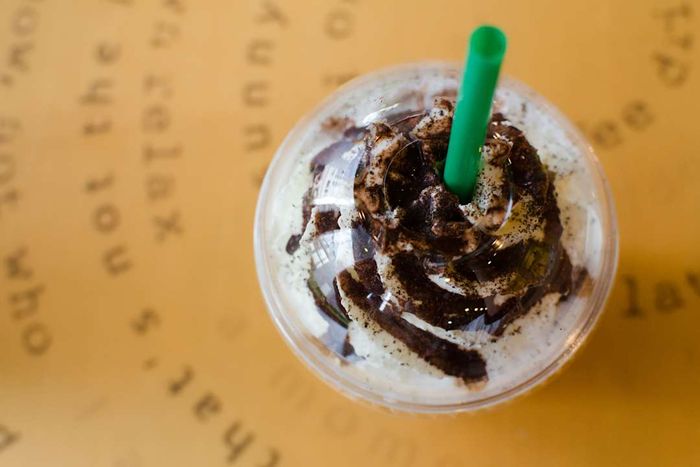 A bird's-eye view of a frappe drink paired with a green straw