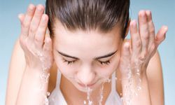 A radiant woman cleansing her face