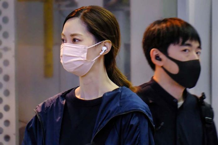 A Japanese man and woman wearing face masks