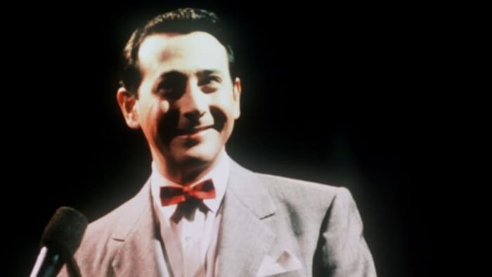 Paul Reubens portraying his iconic character, Pee-wee Herman.