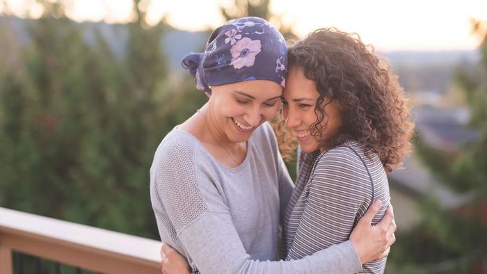 A woman with cancer embracing her sister