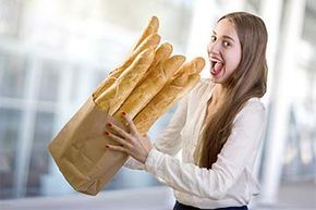 A young girl eating slices of bread