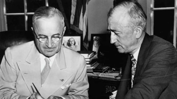 Harry S Truman signs the U.N. charter into effect
