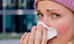 woman blowing her nose