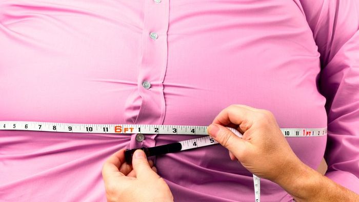 Measuring the waistline of an obese individual