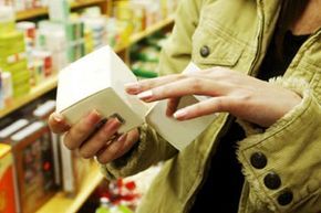 A woman examining a product label closely