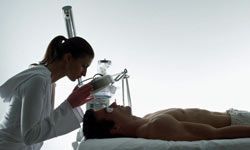 a woman inspecting a man's facial skin