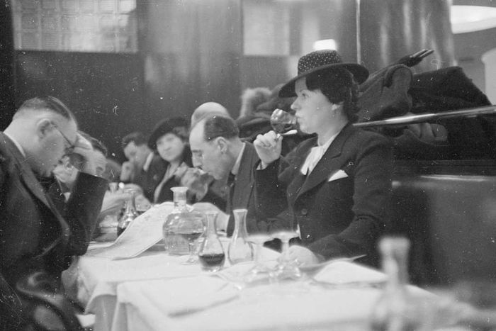 A woman enjoying wine at a restaurant