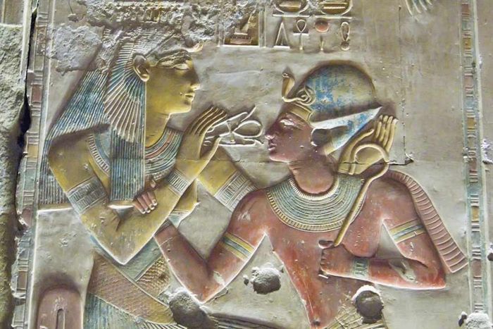 Egyptian stone carving depicting Pharaoh Seti I (on the right) with the Goddess Hathor.