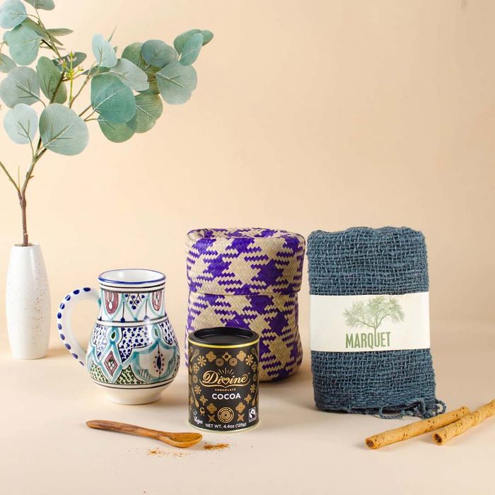 The GlobeIn Box includes items like cocoa mix, a cozy blanket, and more.