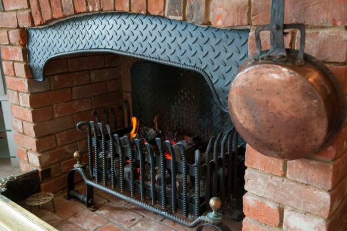 A dying fire in a hearth.