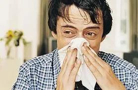 photo of a person blowing their nose
