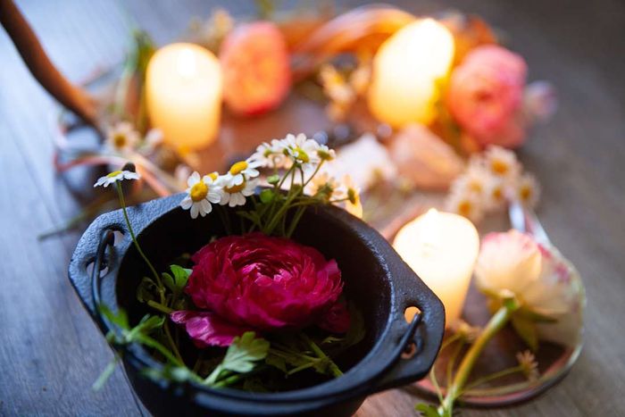An altar adorned with flowers and candles for Beltane