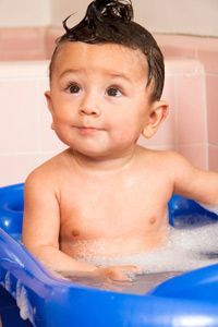 Adorable baby enjoying bath time.
