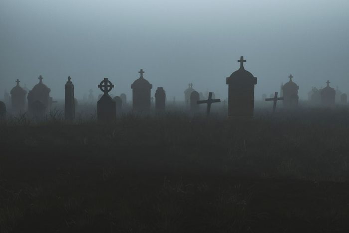 A graveyard illuminated at night