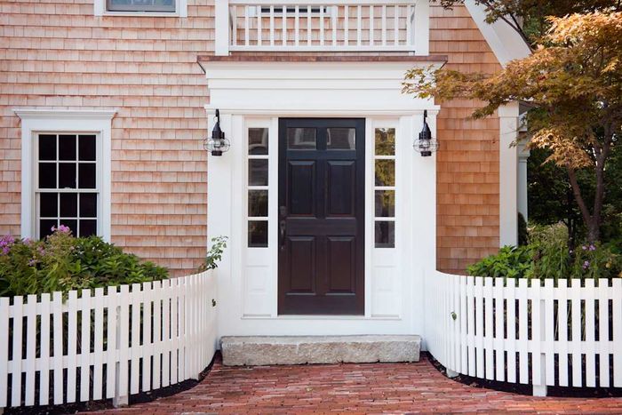 Exterior of a house featuring a white picket fence