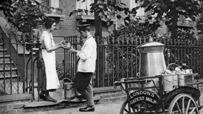 A milkman delivering milk to a North London resident, circa 1926-1927.