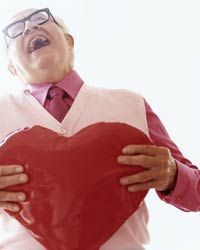 An elderly man holding a heart-shaped object