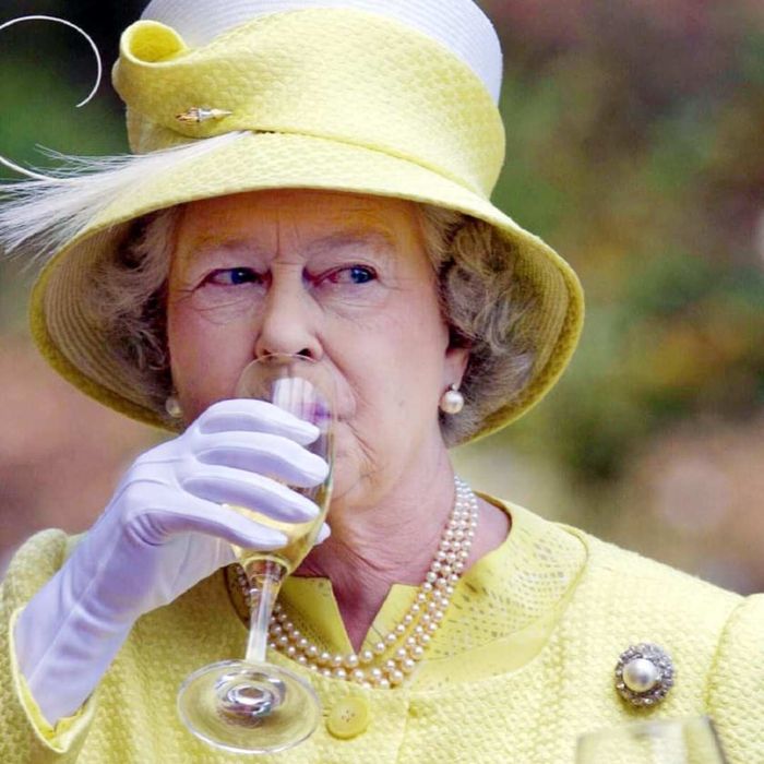 Queen Elizabeth II enjoying a drink.