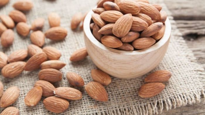 These almonds develop within a soft, fleshy fruit.