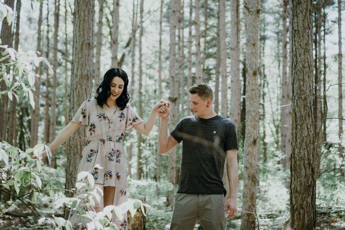 A couple strolling hand in hand through a peaceful forest path, symbolizing their connection and closeness.