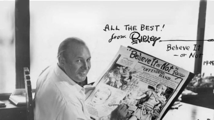 A photograph captures cartoonist Robert Ripley standing before his drawing board in the late 1940s.